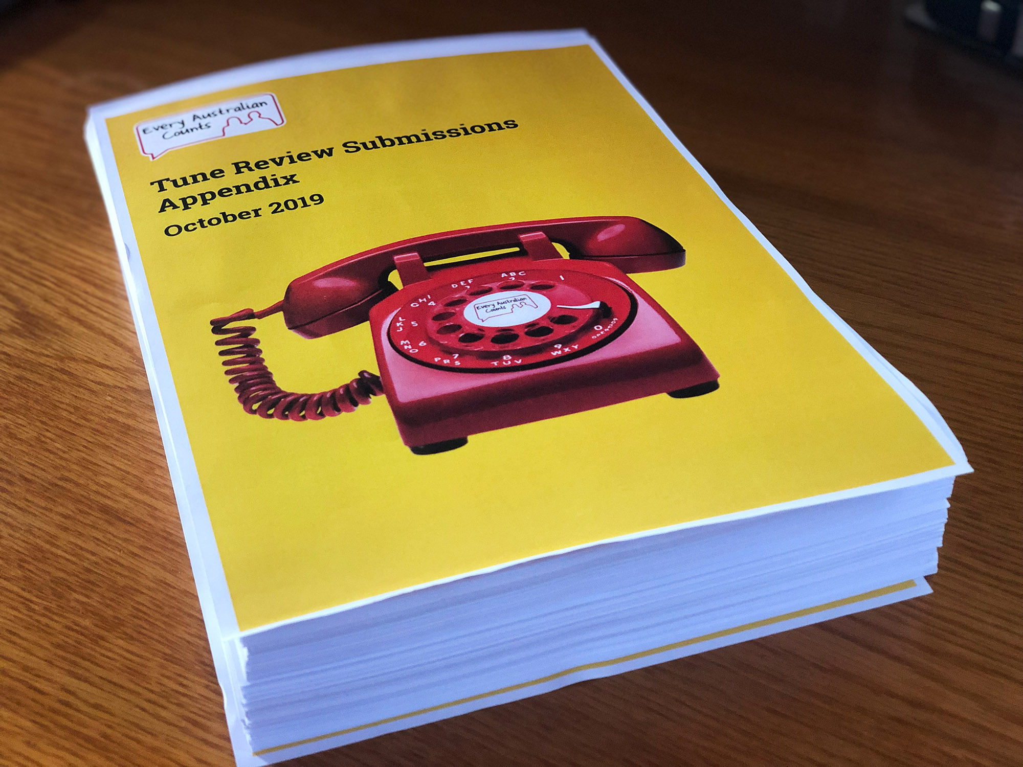 An enormous pile of papers - like a yellow pages. The pile is not bound. On the top is the front cover of the Tune Review Submissions Appendix, and a picture of a red phone on a yellow background.