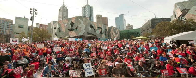 Large crowd in red t-shirts,Every Australian Counts rally, Federation Square Melbourne 2012, Dr George on the bottom left