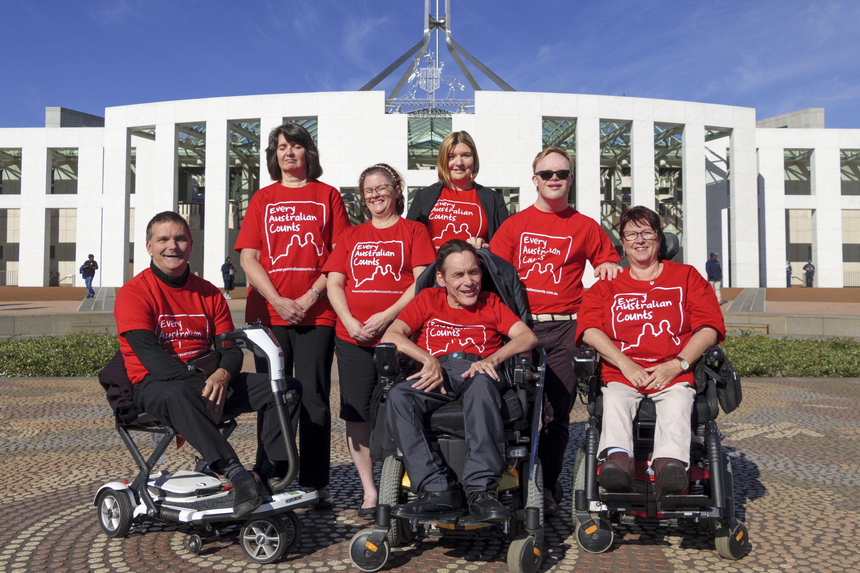 Every Australian Counts Champions stand together in their red t-shirts at Parliament House in Canberra