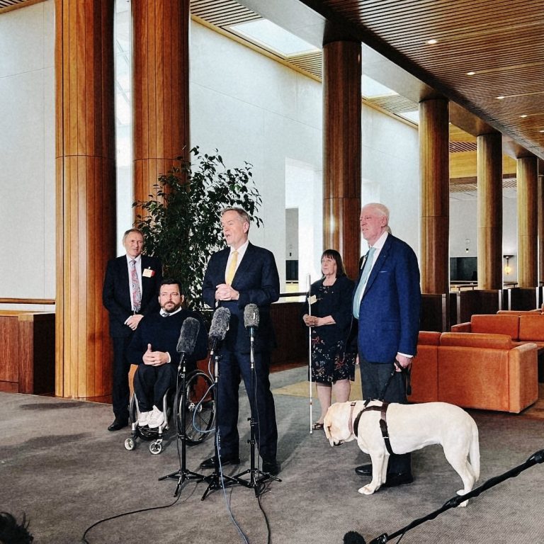 Photo from press conference at Parliament House showing left to right: NDIA Board Member Jim Minto, NDIA Board Chair Kurt Fearnley, NDIS Minister Bill Shorten, NDIS Board member Maryanne Diamond, NDIA CEO Rebecca Falkingham - who is not easily visible, she is behind Dr Graeme Innes (with his Guide Dog).