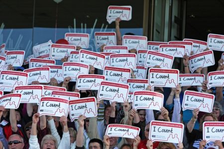 A group of supporters holding up "I count" signs