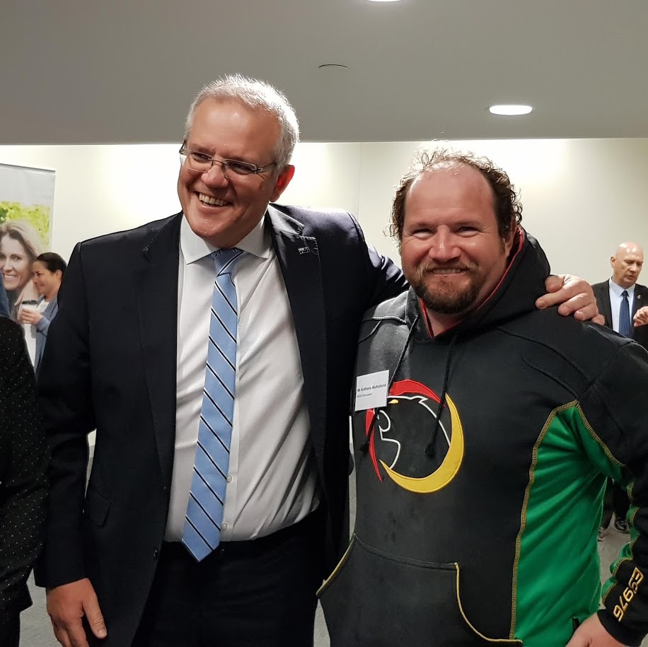Prime Minister Scott Morrison with his arm resting on Anthonys shoulder. They are both smiling.