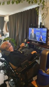 Dr George Taleporos watching NDIS Minister Bill Shorten on a computer screen