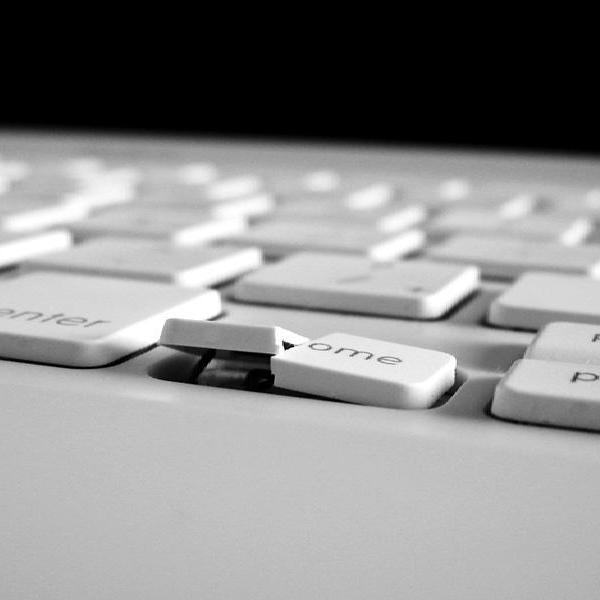 A MacBook keyboard with a broken home key