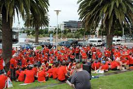 Heaps of Every Australian Counts supporters wearing red tshirts on the foreshore in Geelong