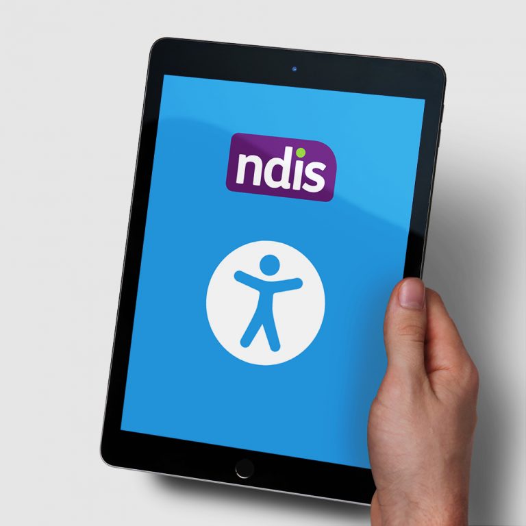 Photo of a hand holding an iPad. The screen has a blue background with the Apple universal access symbol, and the NDIS logo.