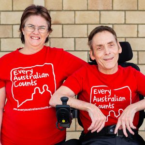 Linda and Peter Tully wearing bright red Every Australian Counts teeshirts
