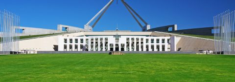 Picture of Australian parliament house including lawn on a sunny blue sky day
